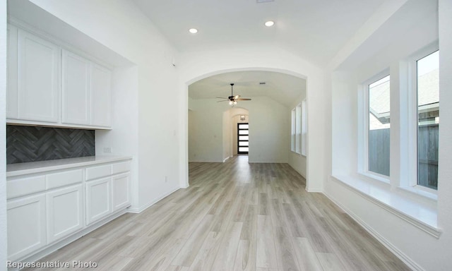 interior space with vaulted ceiling and light wood-type flooring