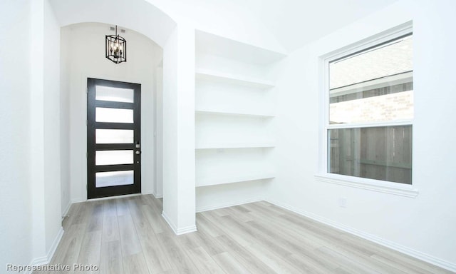 foyer featuring light hardwood / wood-style floors and an inviting chandelier