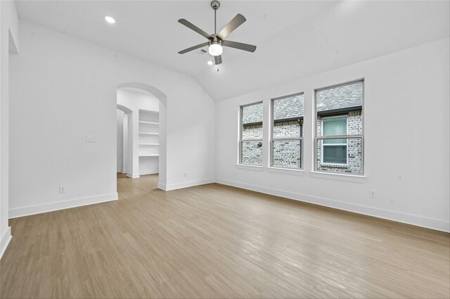 kitchen featuring ventilation hood, stainless steel appliances, sink, white cabinetry, and an island with sink