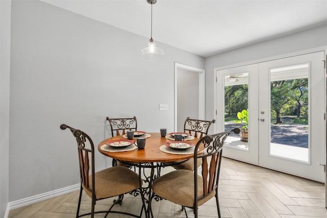 dining area with light parquet flooring and french doors