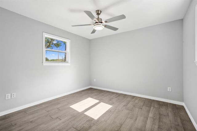 unfurnished room featuring light hardwood / wood-style floors and ceiling fan