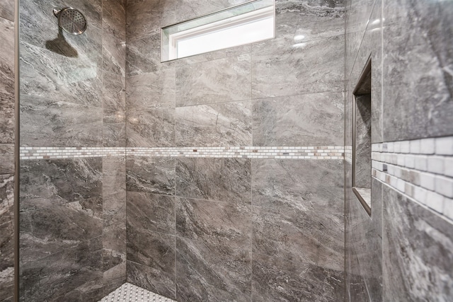 bathroom with tiled shower