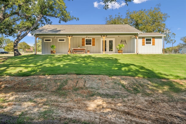 rear view of property with a lawn and french doors