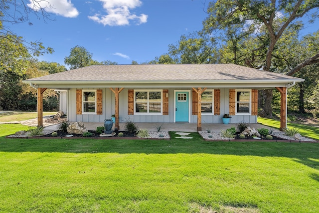 ranch-style home with a front lawn and covered porch