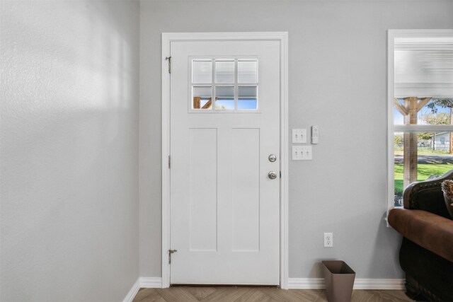 foyer entrance with light parquet flooring