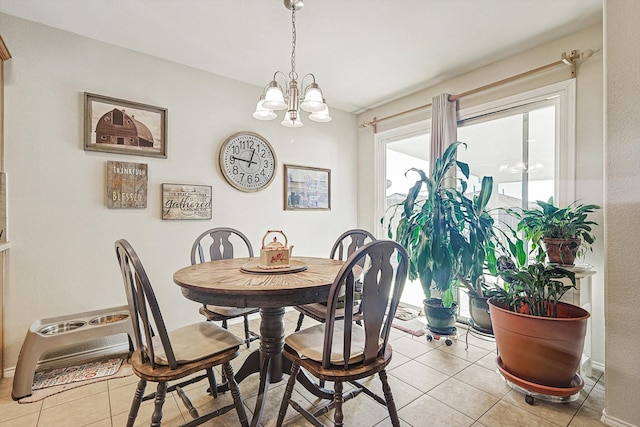 tiled dining area featuring an inviting chandelier