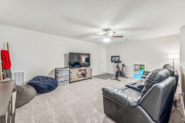 carpeted living room with ceiling fan