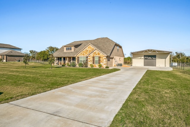 view of front of property with a garage, an outdoor structure, and a front yard