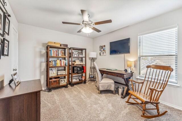 home office featuring light carpet and ceiling fan