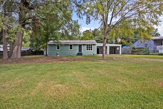 rear view of house featuring a lawn