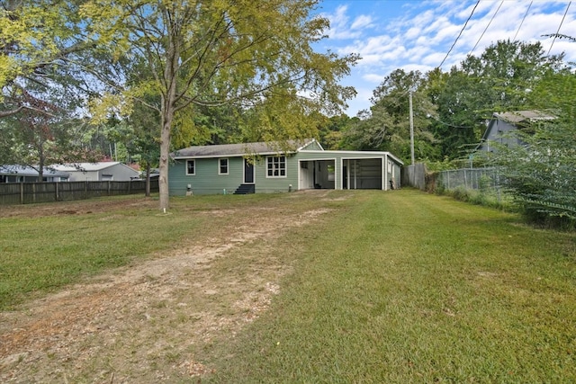 back of property with a yard and a carport