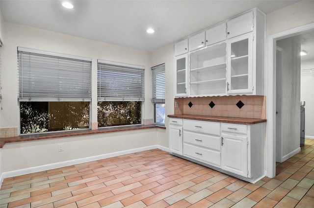 kitchen with decorative backsplash and white cabinetry