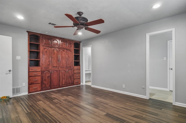 unfurnished bedroom featuring ceiling fan, dark hardwood / wood-style flooring, and connected bathroom