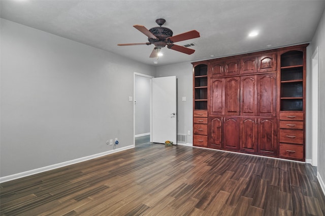 unfurnished bedroom featuring dark hardwood / wood-style floors and ceiling fan