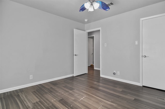 unfurnished bedroom with ceiling fan and dark wood-type flooring