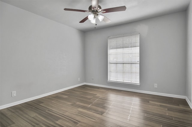 empty room with ceiling fan and dark hardwood / wood-style flooring