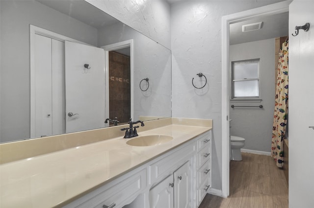 bathroom with a shower with curtain, vanity, and toilet