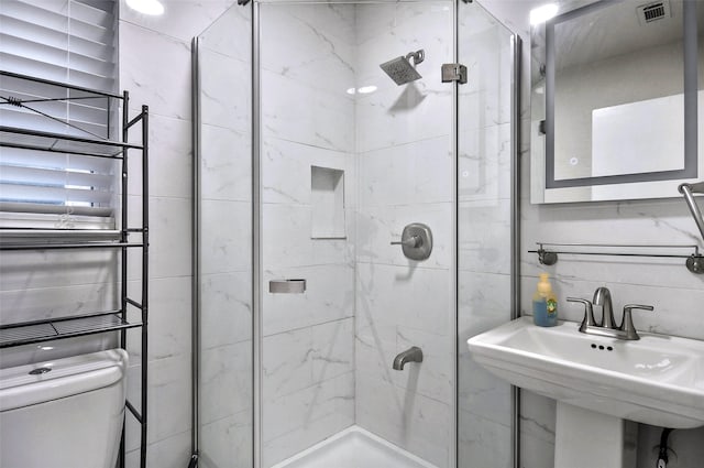 bathroom with sink, toilet, and walk in shower