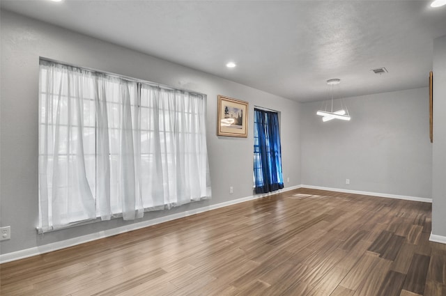 unfurnished room featuring hardwood / wood-style flooring