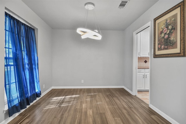 unfurnished dining area featuring hardwood / wood-style flooring