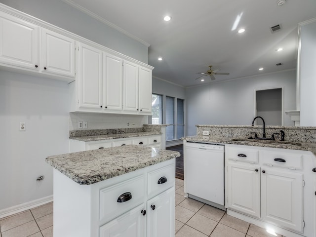 kitchen featuring sink, dishwasher, white cabinets, a kitchen island, and kitchen peninsula