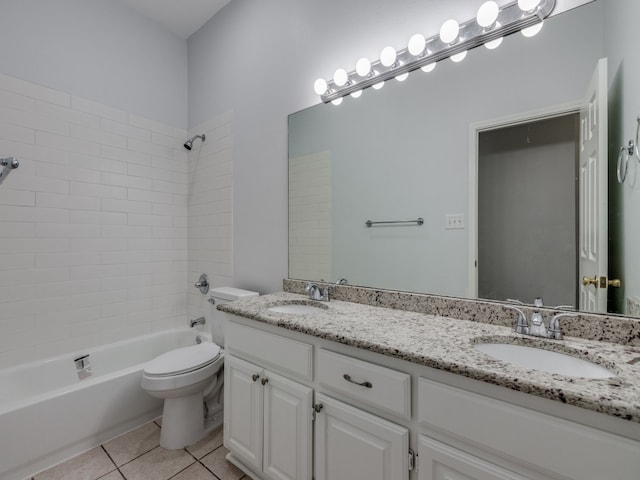 full bathroom with tile patterned floors, toilet, tiled shower / bath combo, and vanity