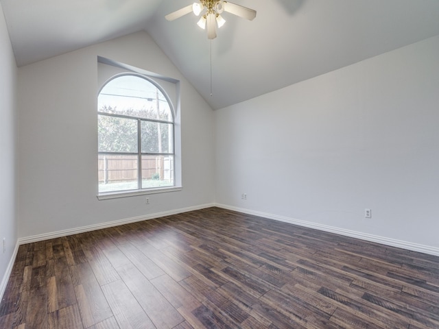 empty room with dark hardwood / wood-style flooring, lofted ceiling, and ceiling fan