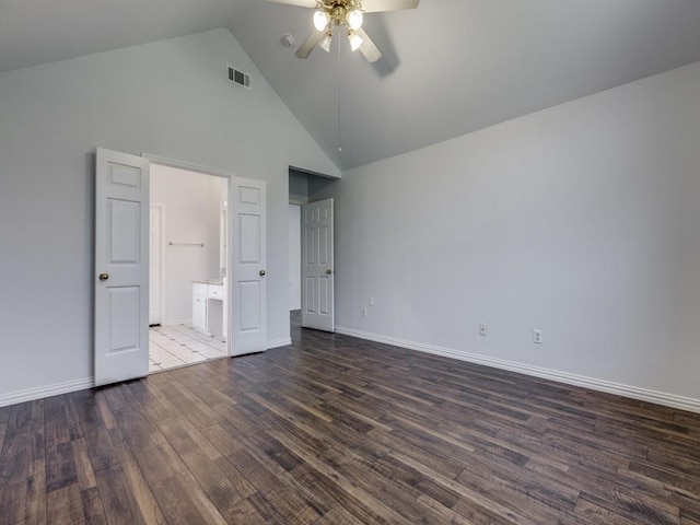 unfurnished bedroom featuring ceiling fan, ensuite bathroom, dark hardwood / wood-style flooring, and high vaulted ceiling