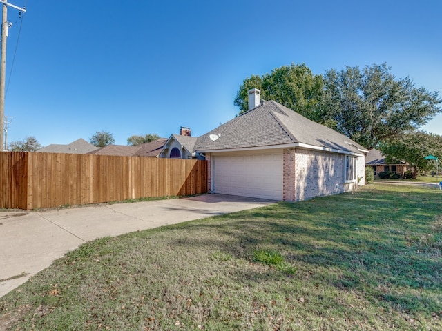 garage featuring a lawn