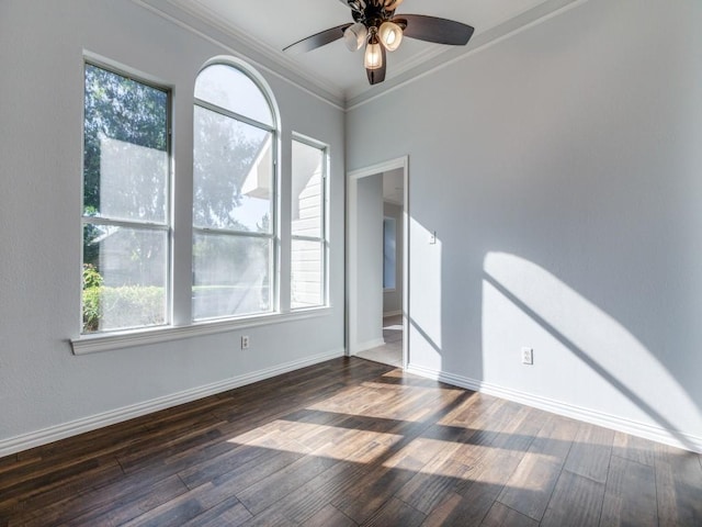 empty room with ceiling fan, ornamental molding, and dark hardwood / wood-style floors