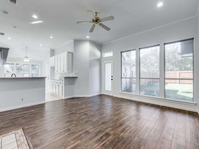 unfurnished living room with crown molding, dark wood-type flooring, and ceiling fan