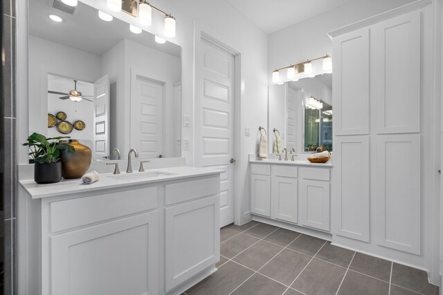 bathroom with tile patterned flooring, vanity, and ceiling fan