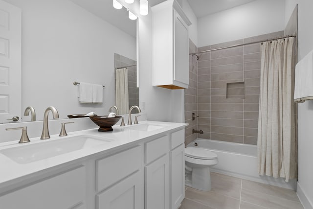 full bathroom featuring toilet, tile patterned floors, vanity, and shower / tub combo with curtain