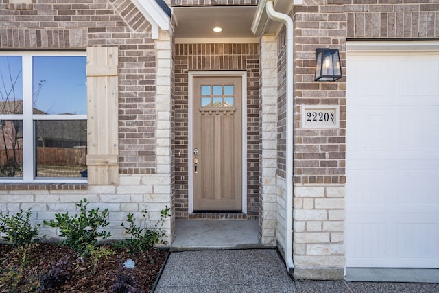 view of exterior entry featuring a garage