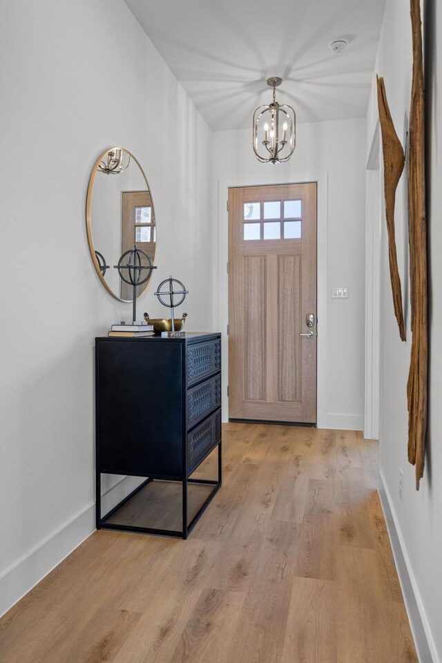 foyer featuring a notable chandelier and light wood-type flooring