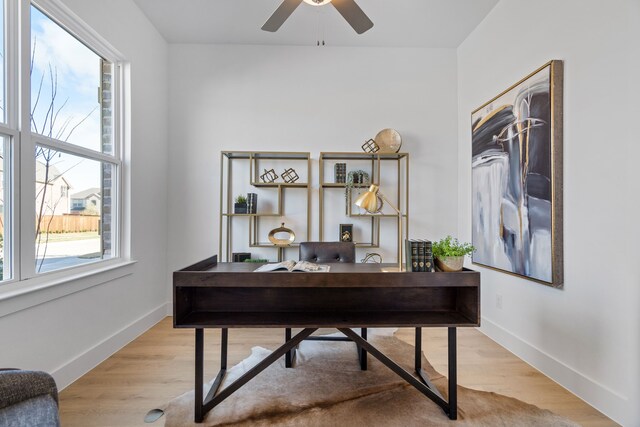 office area with ceiling fan, a healthy amount of sunlight, and light wood-type flooring