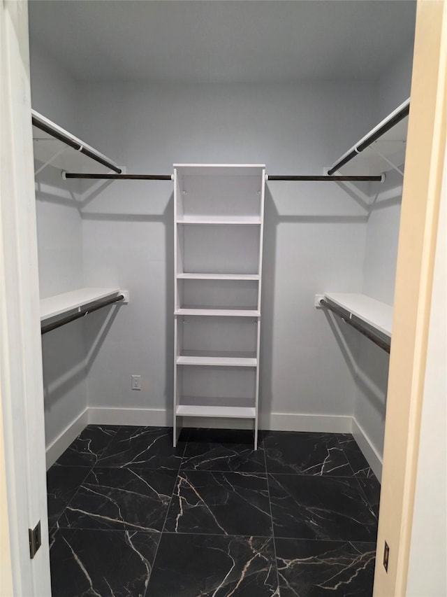 3612 Broken Bow Dr, Granbury, TX 76048 - walk in closet featuring dark marble finish flooring