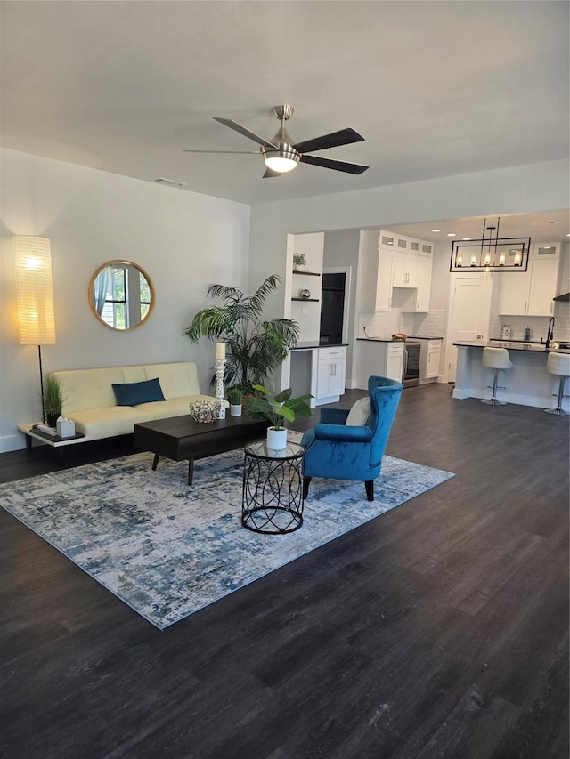 3612 Broken Bow Dr, Granbury, TX 76048 - living room with dark wood-style floors, ceiling fan, baseboards, and wine cooler