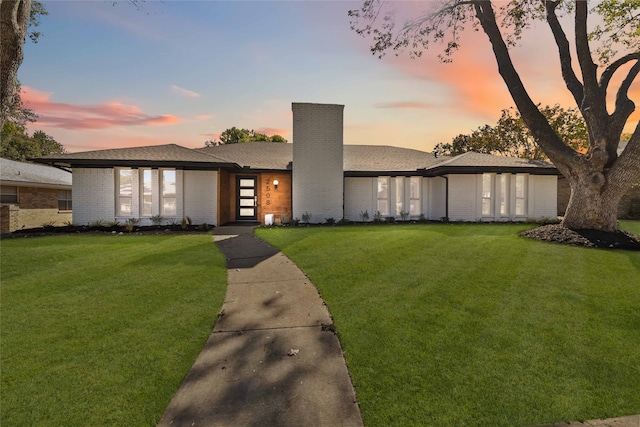 prairie-style home featuring a yard