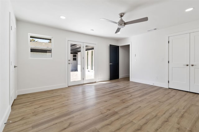 unfurnished bedroom featuring ceiling fan, light hardwood / wood-style floors, and multiple windows