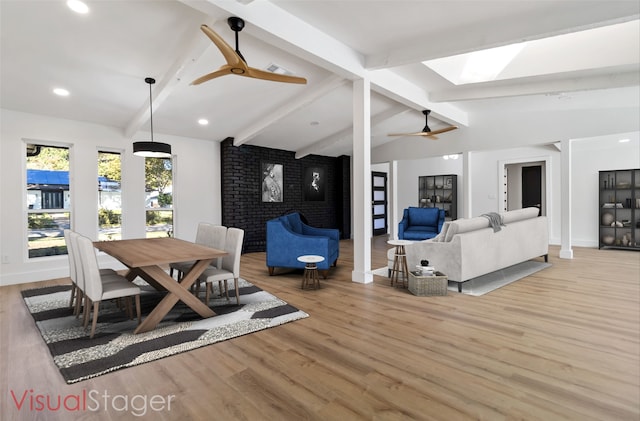 dining area with vaulted ceiling with beams, light wood-type flooring, and ceiling fan