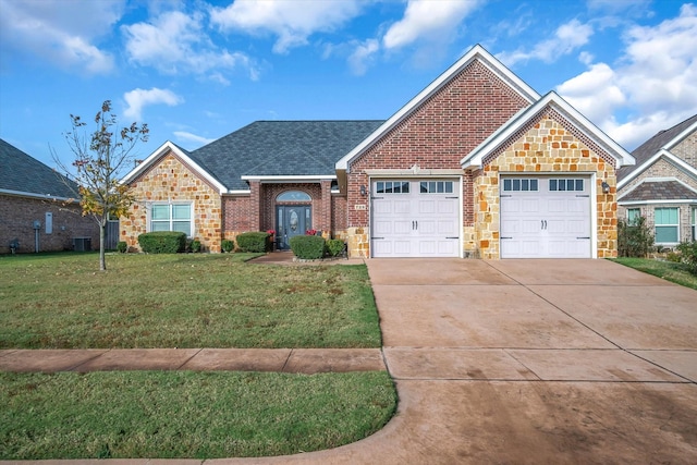 view of front of house with central AC unit, a garage, and a front lawn