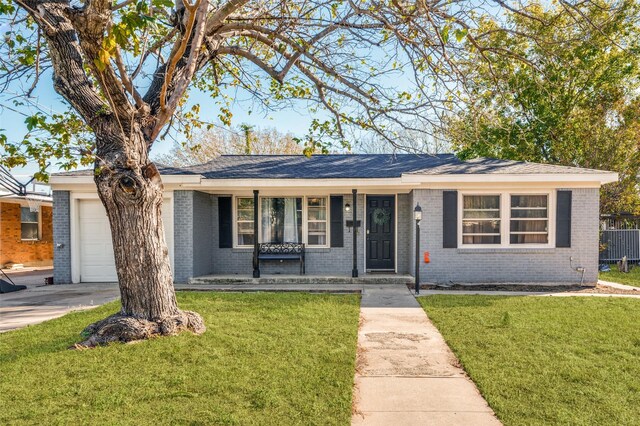 single story home featuring a porch, a garage, and a front lawn