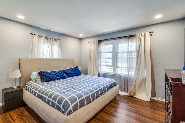 bedroom featuring dark hardwood / wood-style floors and multiple windows