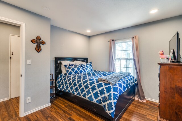 bedroom with dark wood-type flooring