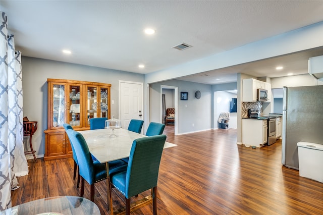 dining area with dark wood-type flooring