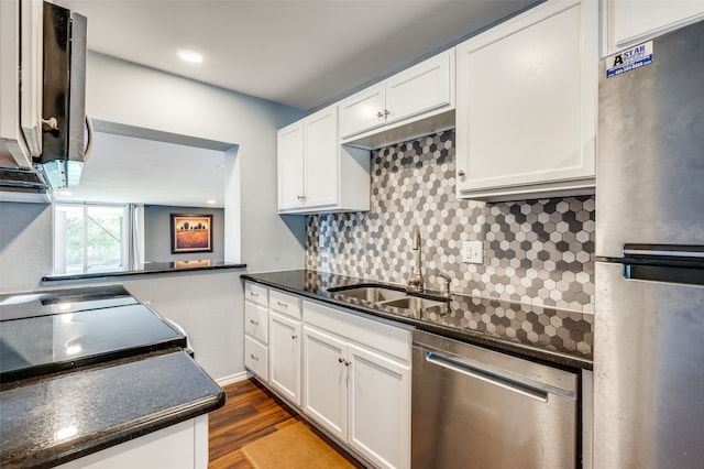 kitchen featuring white cabinetry, sink, tasteful backsplash, and stainless steel appliances