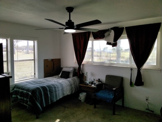 bedroom with multiple windows, carpet floors, and ceiling fan