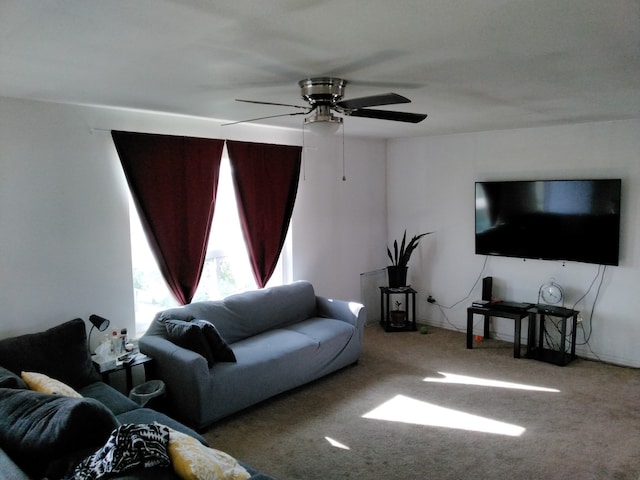 carpeted living room with ceiling fan