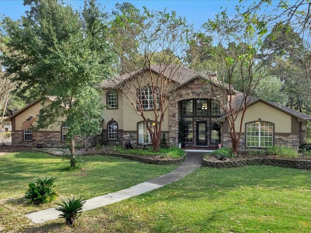 view of front of home with stone siding, stucco siding, and a front yard